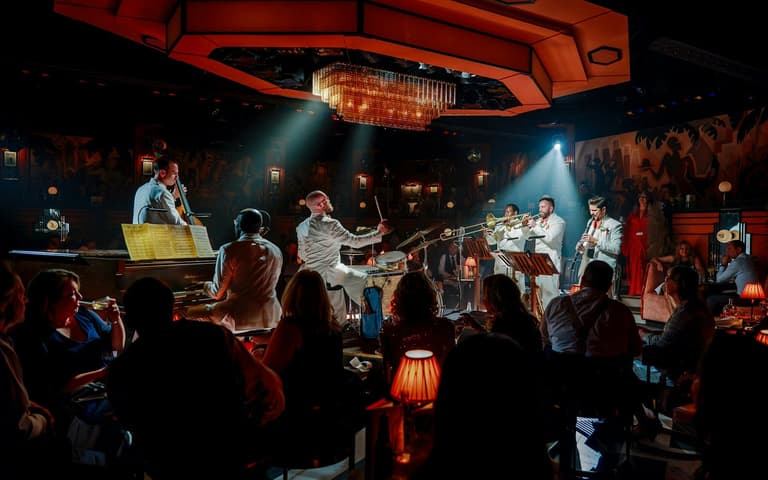 The 58th Street Stompers house band performing to a seated audience in the 1930s speakeasy room at 58th Street in Peckham