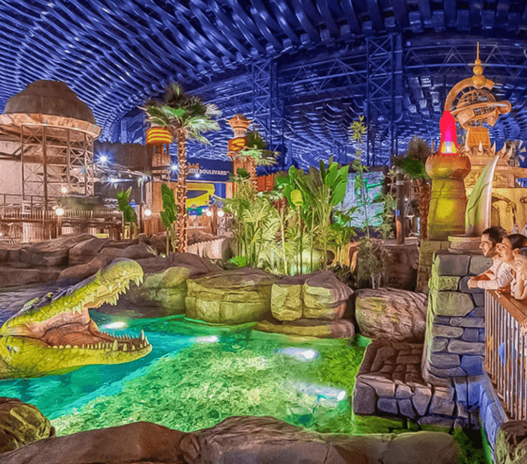 Indoor jungle adventure park with a giant crocodile and green lagoon in Dubai