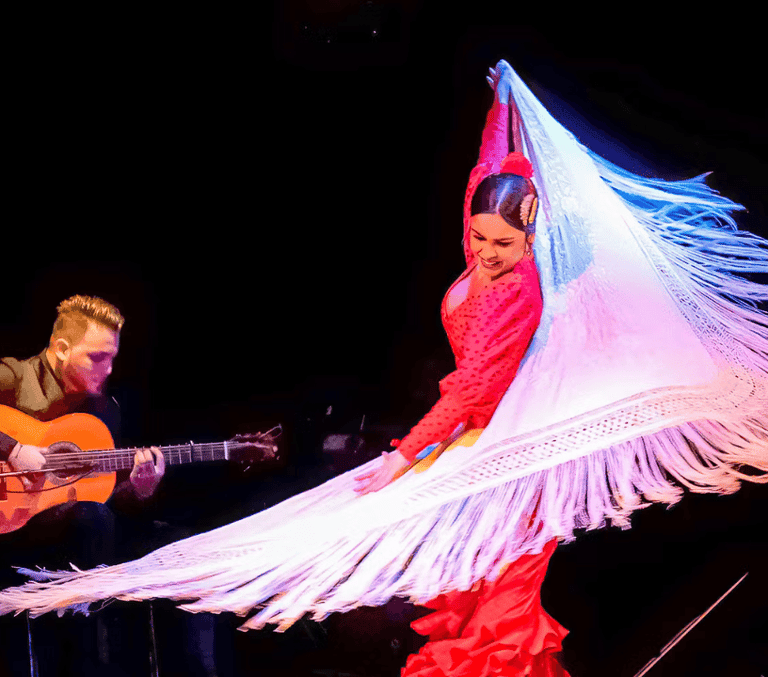 Flamenco dancer in red with white shawl and guitarist in Barcelona