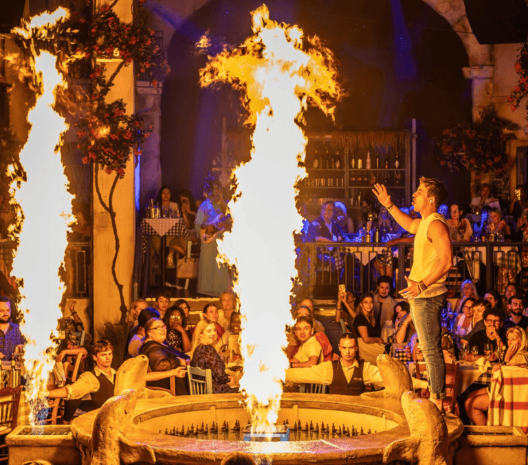 A flaming fountain centrepiece surrounded by guests during the Mamma Mia! The Party show at The O2