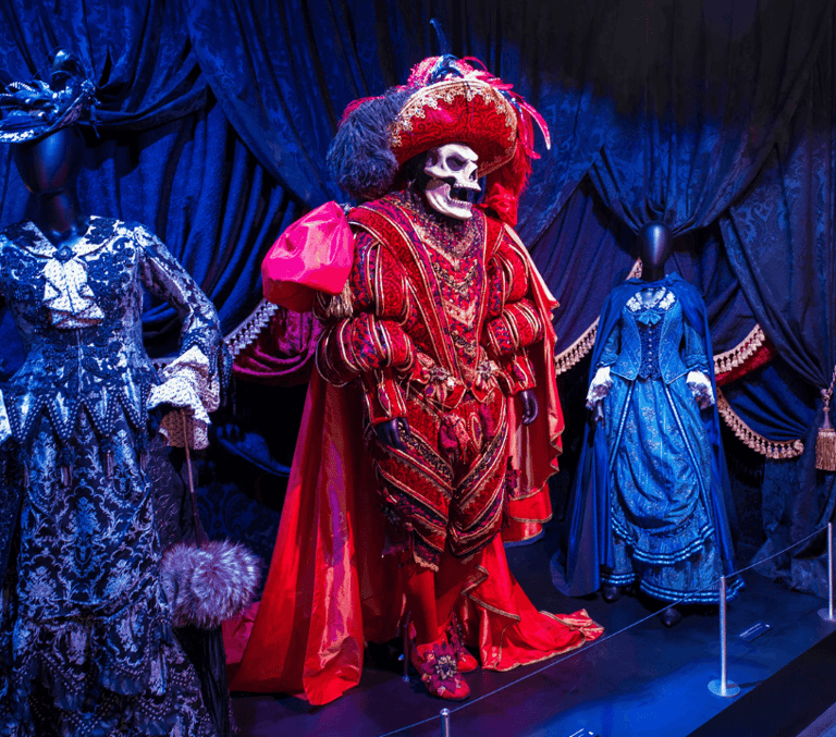 Ornate red theatrical costume on display at a Midtown Manhattan indoor exhibition