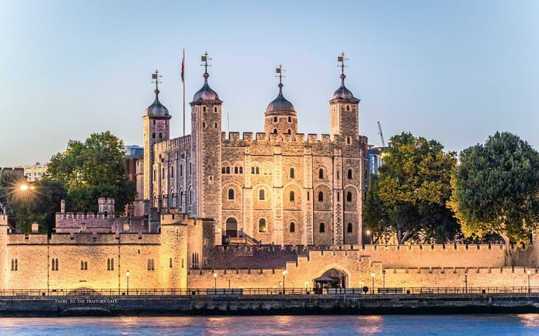 The Tower of London illuminated at dusk during an after-hours evening tour