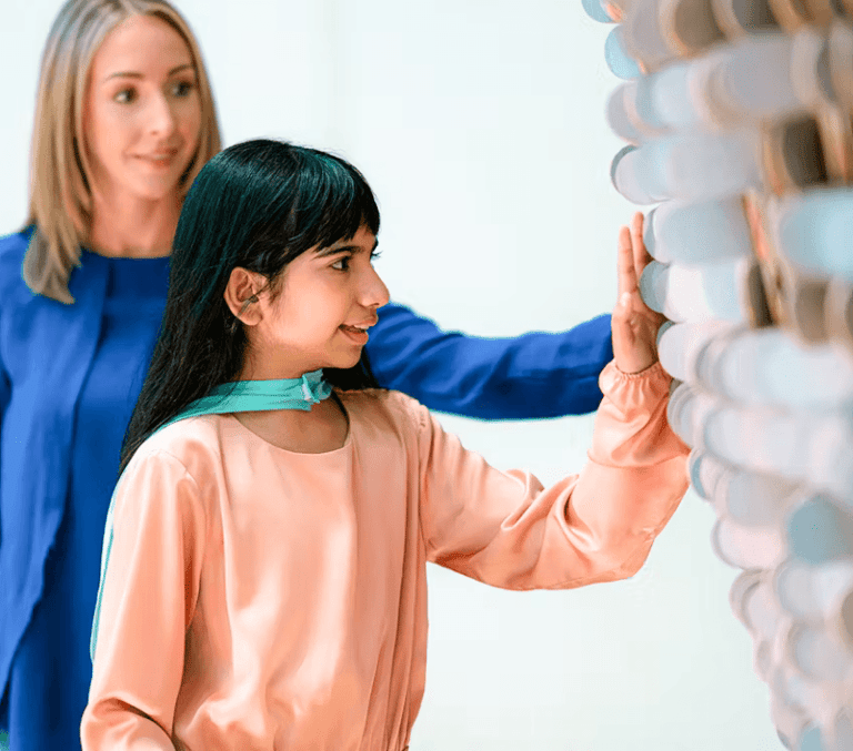 Child touching an interactive exhibit at Dubai Museum of the Future