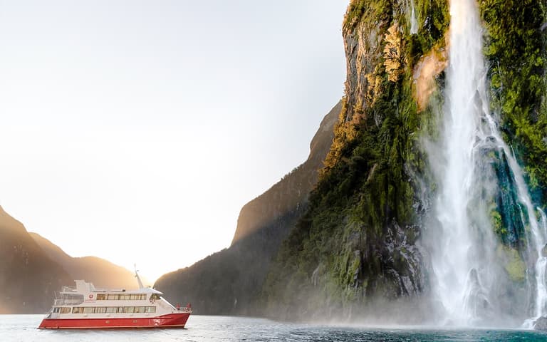 Helicopter landed on a snow-covered glacier high above Milford Sound