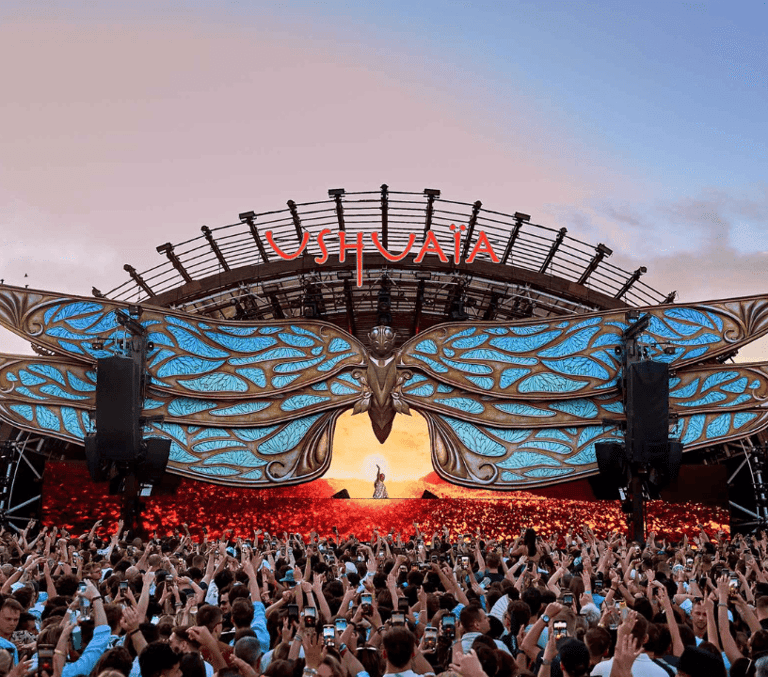 The vast Ushuaia Ibiza open-air stage and crowd glowing at sunset