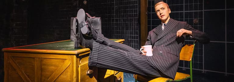 Taking a break at the desk in Operation Mincemeat at the Golden Theatre