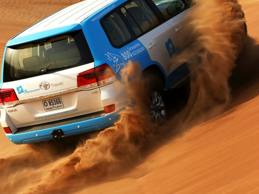 Morning Desert Safari: Dune Bashing, Sandboarding and Camel Rides
