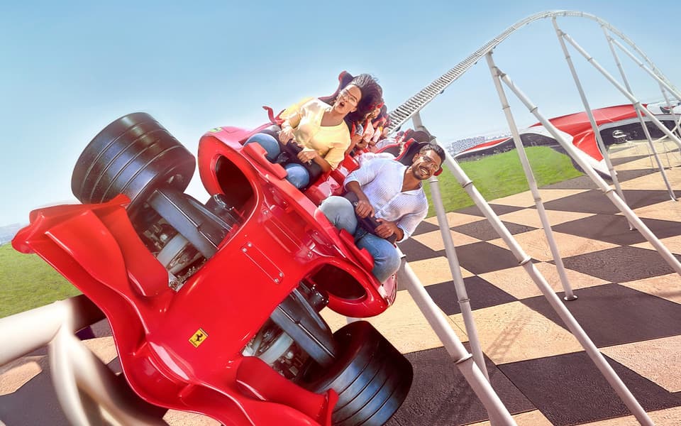 A family enjoys a roller coaster ride at Abu Dhabi's Ferrari World