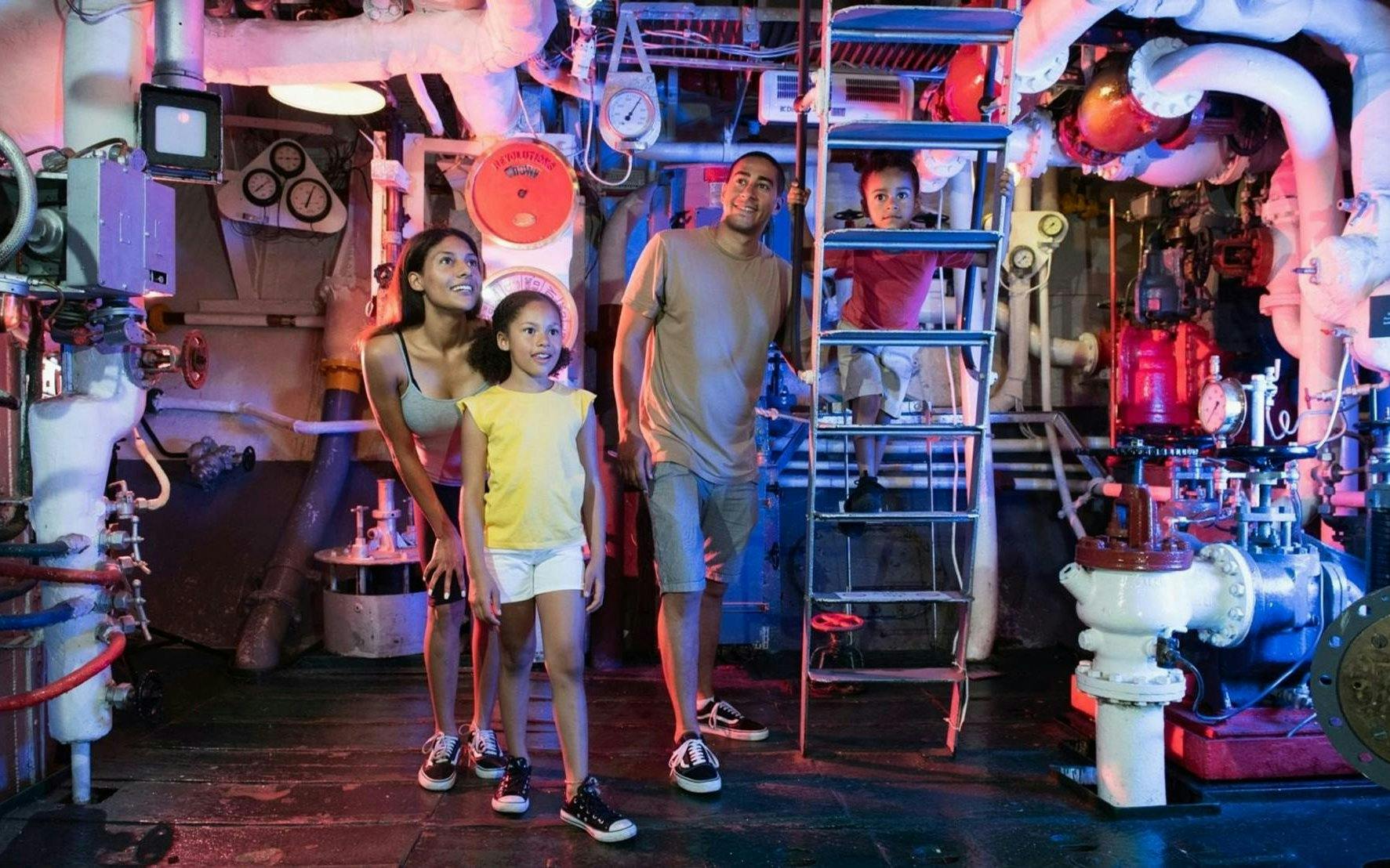 Visitors exploring machinery below deck