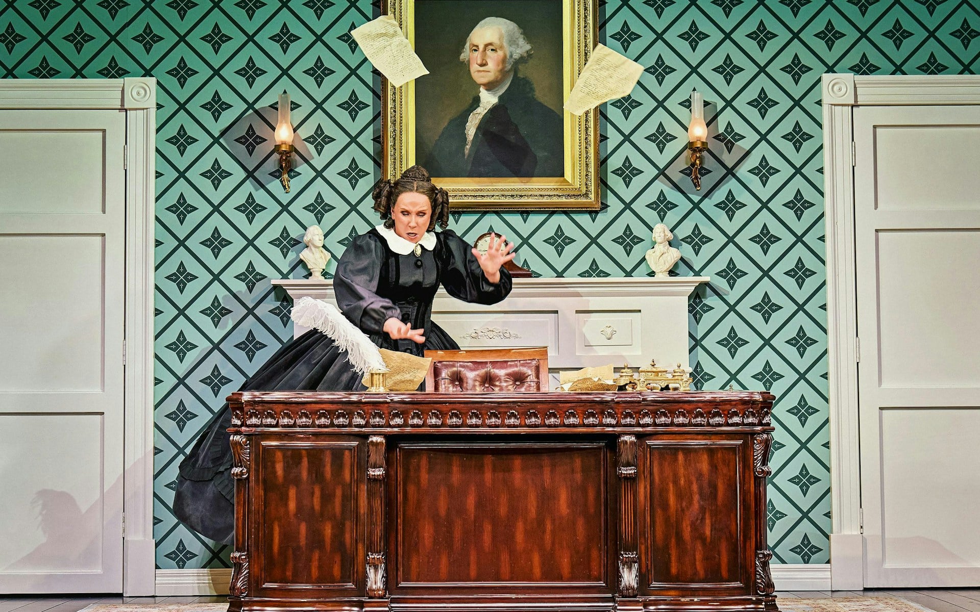 Mary Todd Lincoln in a black mourning gown at a desk in Oh, Mary! at the Trafalgar Theatre
