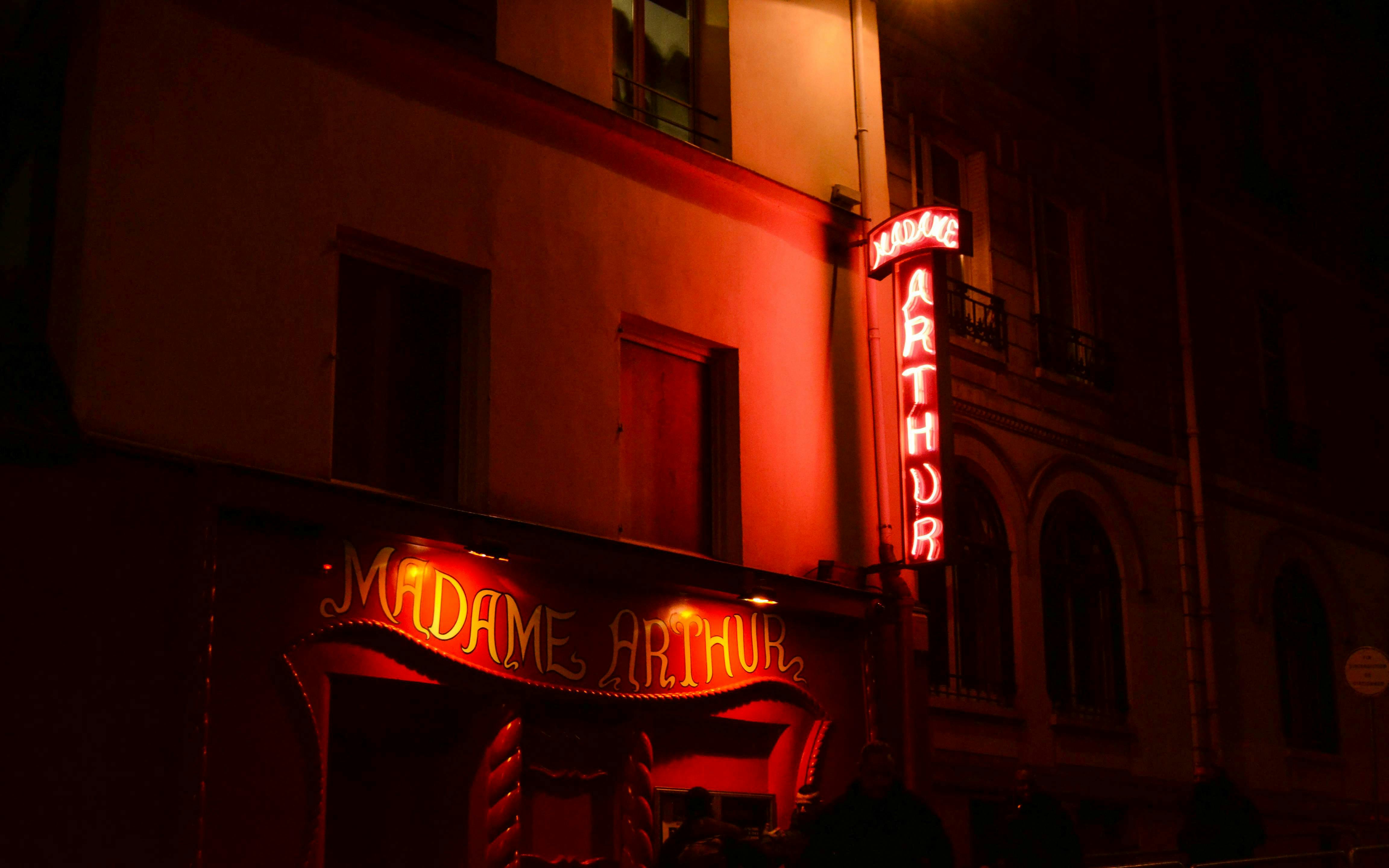 Madame Arthur cabaret entrance with neon lights in Paris.