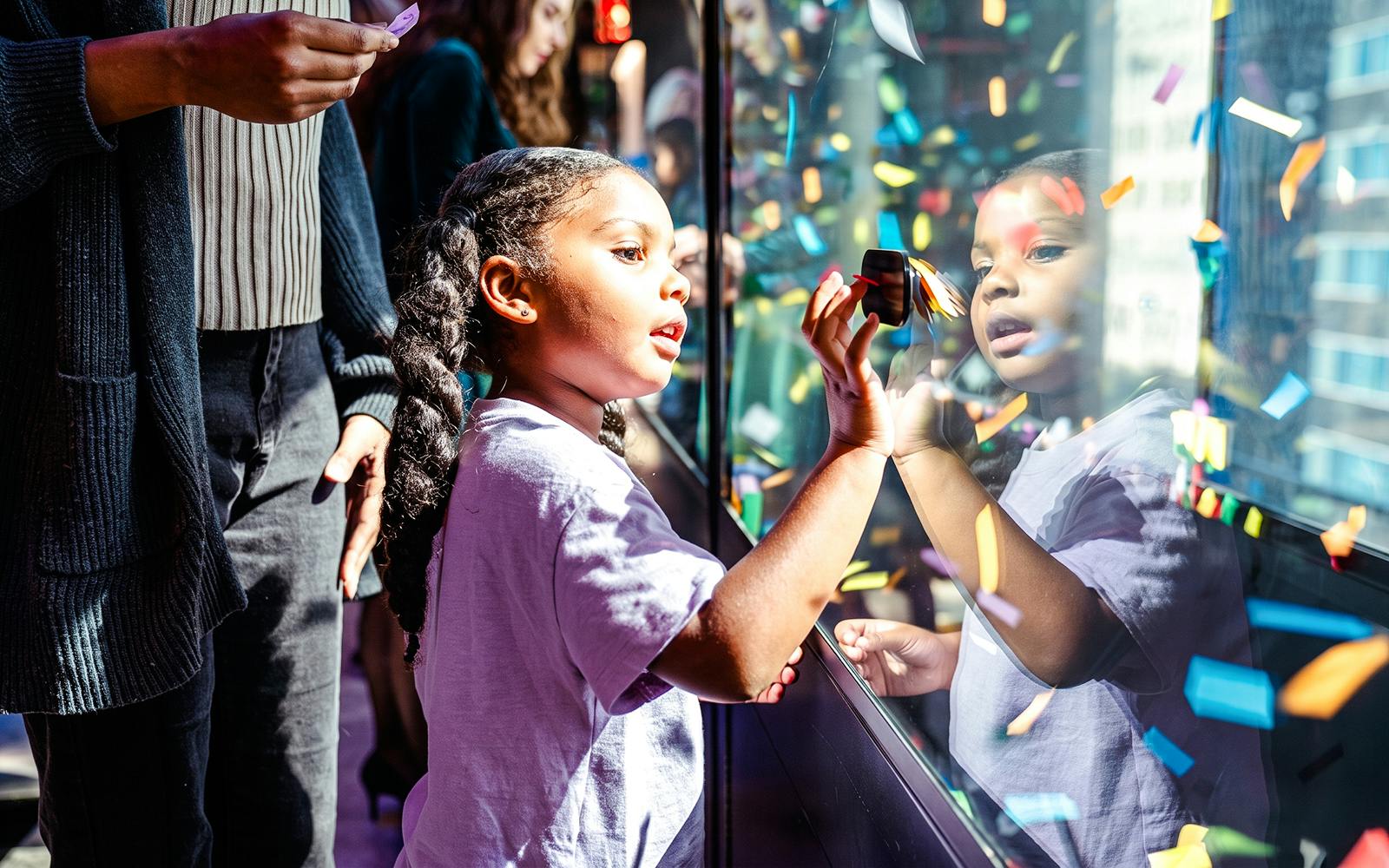 Child exploring a display at One Times Square