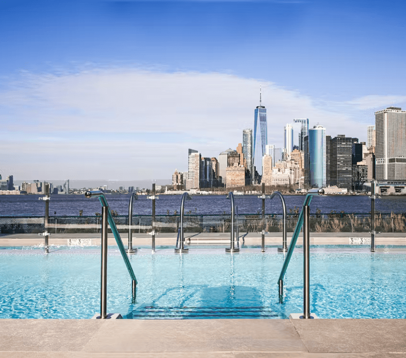 QC Spa outdoor hot spring with the Manhattan skyline in the background.