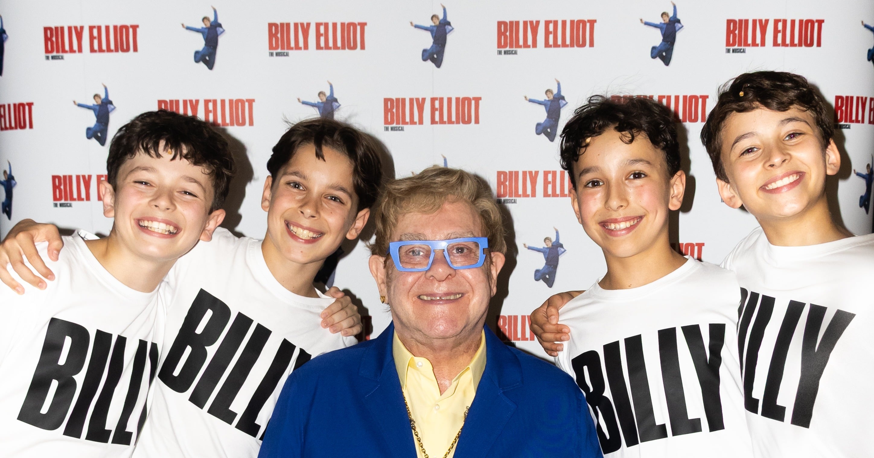 Elton John seated with the four new Billy Elliot actors, Noah Mannion, Rafferty Smale, Spencer Collins and William Gurney