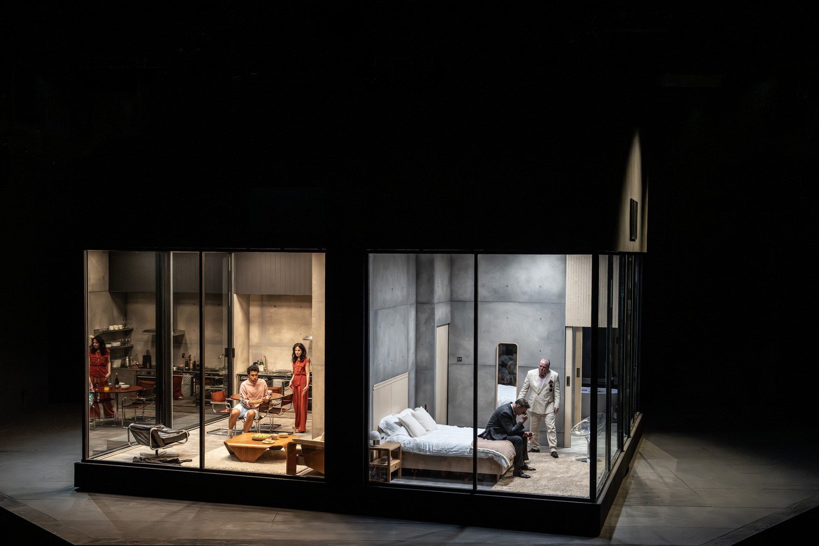 The cast of The Oresteia in the glass-walled set at the Bridge Theatre